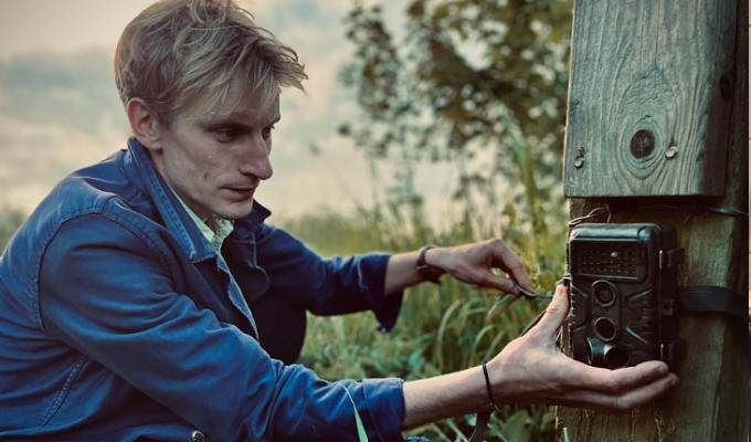 Charlie attaching a camera to a post