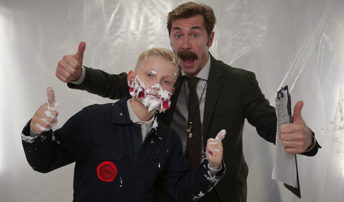 Mike with Junior Taskmaster contestant with custard pie on his face